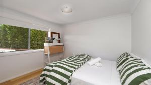 En eller flere senge i et værelse på Paradise - Pearl - Modern With Wifi