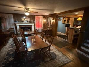ein Esszimmer mit Tisch und Stühlen und einem Kamin in der Unterkunft Historic Rider's Inn in Mentor