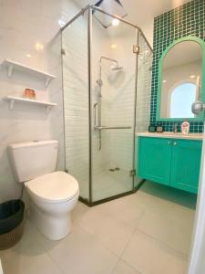 a bathroom with a toilet and a glass shower at UY LONG Homestay Grand World Phú Quốc in Phú Quốc +41 photos