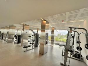 a gym with treadmills and machines in a room at Concepcion Live in Buenos Aires