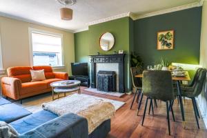 a living room with a couch and a table at Cruachan House in Falkirk