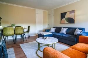 a living room with a blue couch and a table at Cruachan House in Falkirk
