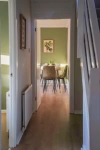 a hallway leading to a dining room with a table at Cruachan House in Falkirk +38 photos