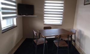 a dining room with a wooden table and chairs at Claudette Guest House in Michelson