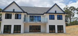 a white house with a black roof at Redhill Batemans Bay in Batemans Bay