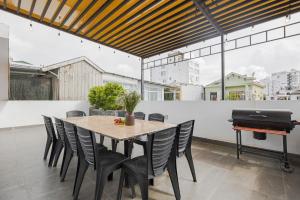 a dining room with a table and a piano at Villa's Võ Thị Sáu Huế in Hue