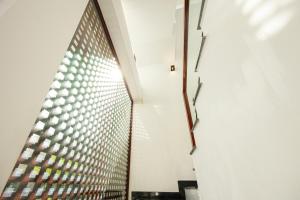 a hallway with a glass wall in a building at Villa's Võ Thị Sáu Huế in Hue