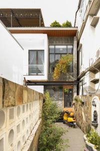 a house with a yellow scooter parked in front of it at Villa's Võ Thị Sáu Huế in Hue
