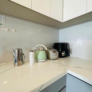 头顿Center Point The Sóng Vung Tau - Infinity Pool的厨房柜台配有茶壶和烤面包机 更多103张照片
