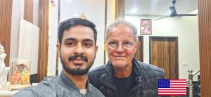 two men standing next to each other with an american flag at Hotel Anjana Cottage - Stay 5 min Away From Golden Temple in Amritsar