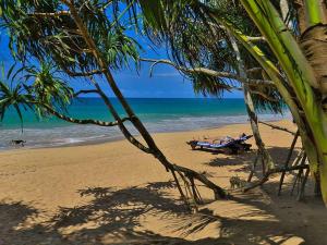 a group of people laying on a beach at Dosemo Cabana in Induruwa +22 photos