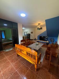 a living room with a wooden bench and a table at Anawin Bungalows in Ao Nang Beach