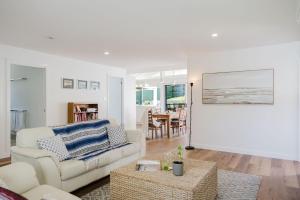 a living room with a couch and a table at Ocean Haze - Putting Green, Firepit, Beach location in Mollymook