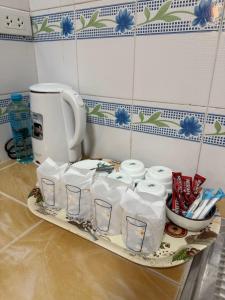 a tray of toilet paper and cups on a counter at Anawin Bungalows in Ao Nang Beach