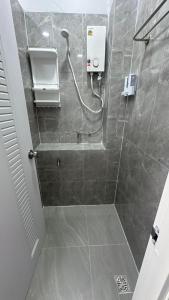 a bathroom with a shower with a soap dispenser at Cosy Hostel in Ko Tao