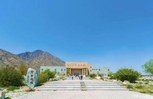 a view of a building with mountains in the background at IU Hotels·Yinchuan Railway Station in Yinchuan
