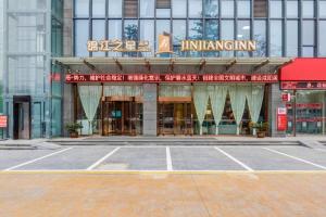 an empty parking lot in front of a building at Jinjiang Inn Select Xixian New Distict Century Avenue in Xianyang