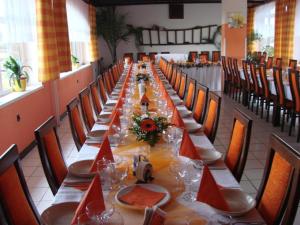 a long dining room with a long table and chairs at Motel Podkova in Klobouky u Brna