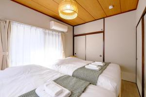 Postel nebo postele na pokoji v ubytování F-City 中葛西 I