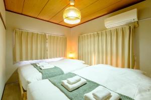 Postel nebo postele na pokoji v ubytování F-City 中葛西 I