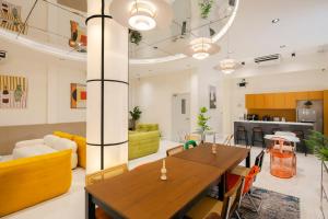 a living room with a table and a couch at Bembis Hotel Charoenakorn 10 in Chinatown