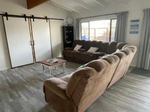 a living room with a couch and a table at The Marlin House Iluka in Iluka