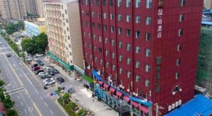 an aerial view of a red building on a street at James Joyce Coffetel· Wuhan Wangjiawan Taojialing Metro Station in Wuhan