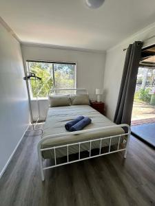 a bed in a room with a large window at Gold Coast Rooms in Gold Coast