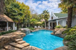 a swimming pool in the backyard of a house at Lodge At The Link in Kempton Park