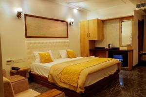 a bedroom with a large bed in a room at NTS Nirvana Suites in Bangalore +34 photos