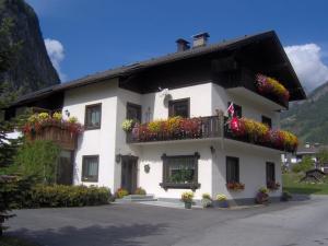 a white building with flower boxes on it at Landhaus Christoph in Heiligenblut