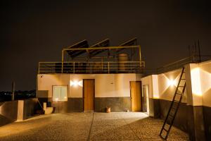 a building with a balcony on top of it at night at NTS Nirvana Suites in Bangalore