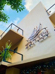a sign on the side of a building with a boat on it at Hotel Santa Cruz Mazunte in Mazunte
