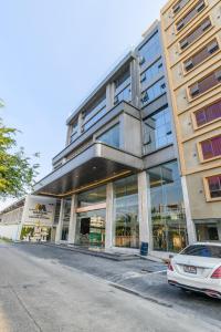 a building with a car parked in front of it at Marquis Hotel in Ban Bang Toei (1)