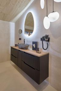 a bathroom with a sink and a mirror at fuchs am meer in Mitterhofen