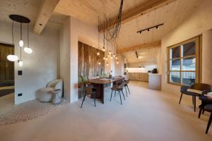 a kitchen and dining room with a table and chairs at fuchs am meer in Mitterhofen