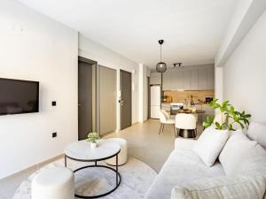 a living room with a couch and a table at Ptolemeon 20, Apts & Studios Thessaloniki Center in Thessaloniki