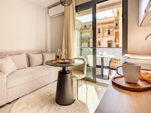a living room with a couch and a table at Ptolemeon 20, Apts & Studios Thessaloniki Center in Thessaloniki +11 photos