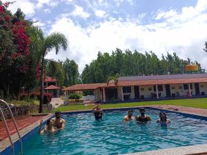 a group of people in a swimming pool at Bougainvillea in Chikmagalūr