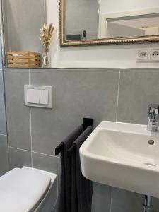 a bathroom with a sink and a mirror and towels at Petkumer Deichkoje in Emden +18 photos