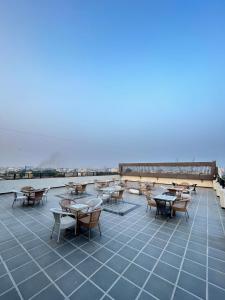 a patio with tables and chairs on top of a building at Hotel Giriraj Palace in Jaipur
