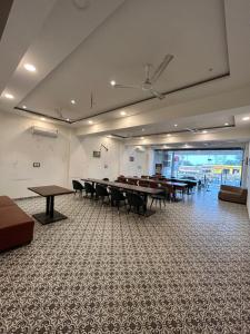 a large room with tables and chairs in it at Hotel Giriraj Palace in Jaipur