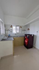 a kitchen with a refrigerator in the middle of a room at Dream stay villaa in Pondicherry