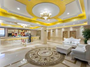 a lobby with white furniture and a gold ceiling at Vienna Hotel Wuhan Guobo Jiangang Metro Station in Wuhan
