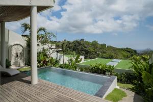 a swimming pool on the deck of a house at Kono Villas & Resort in Ungasan