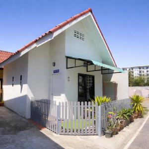 a white house with a white fence and plants at Yada House Alina Cottage in Nai Yang Beach +24 photos
