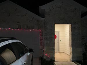 a white car parked in a garage with christmas lights at Homely in Richmond