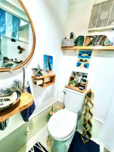 a bathroom with a toilet and a sink at Kasa Gigi in El Nido
