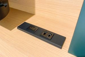 a black electrical outlet on a wooden floor at Comfort Hotel Matsuyama in Matsuyama +35 photos