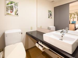 a bathroom with a white toilet and a sink at Comfort Inn Naha Tomari Port in Naha +35 photos